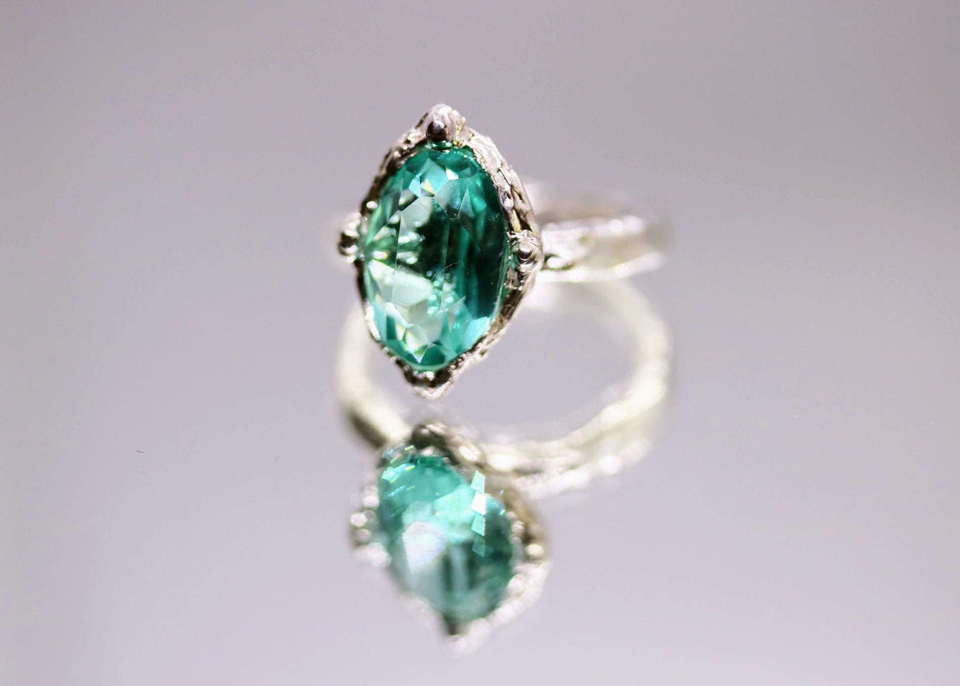 solitaire ring with lab grown paraiba tourmaline